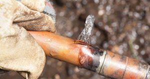 Frozen pipe burst with ice coming out of it